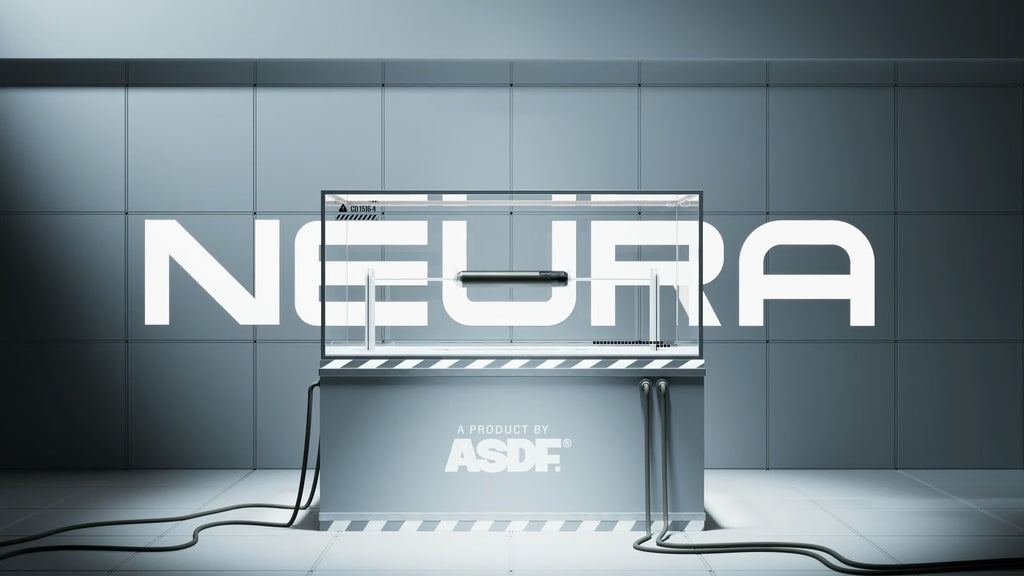 A futuristic gray display stand or enclosure with large white 'NEURA' lettering across the wall behind it and 'A PRODUCT BY ASDF' printed on the front. The setup is shown in a clean, stylized studio-like environment with cables on the floor and a metallic tiled background.