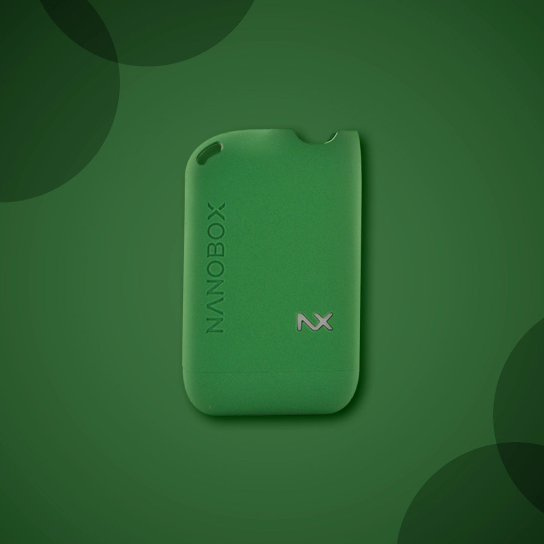 Green NanoBox NX vape device on matching green background