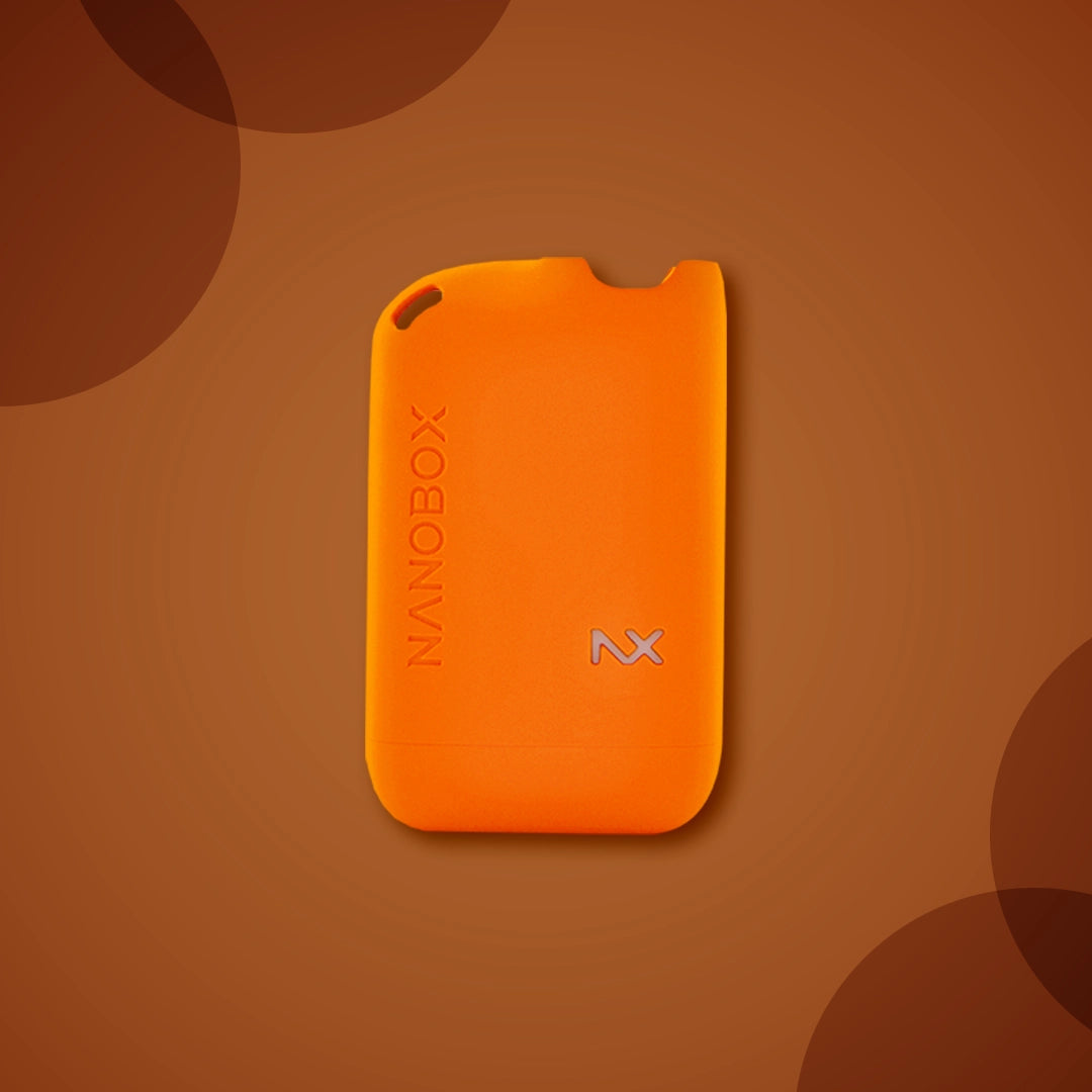 Bright orange Nanobox vape device with NX logo on warm brown background