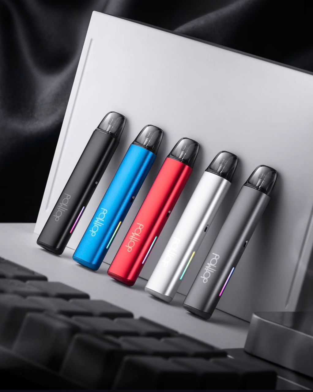 Five colorful dotMod vape pens with LED lights, sleek design, modern setup