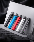 Five colorful dotMod vape pens with LED lights, sleek design, modern setup