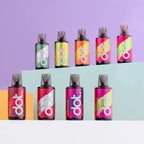 Colorful dot vape pens in assorted flavors like cherry cola, watermelon, and passion fruit on tiered display