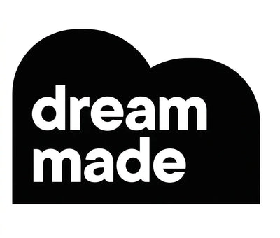 Dream Made logo in bold white text on black cloud shape, minimalist design